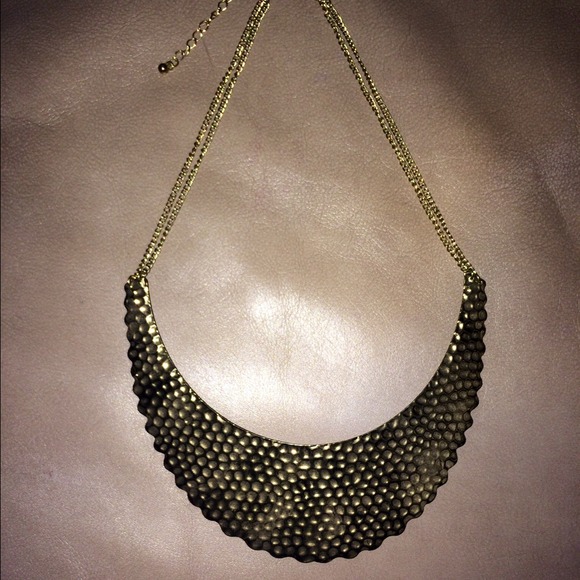 Gold neck forming necklace.