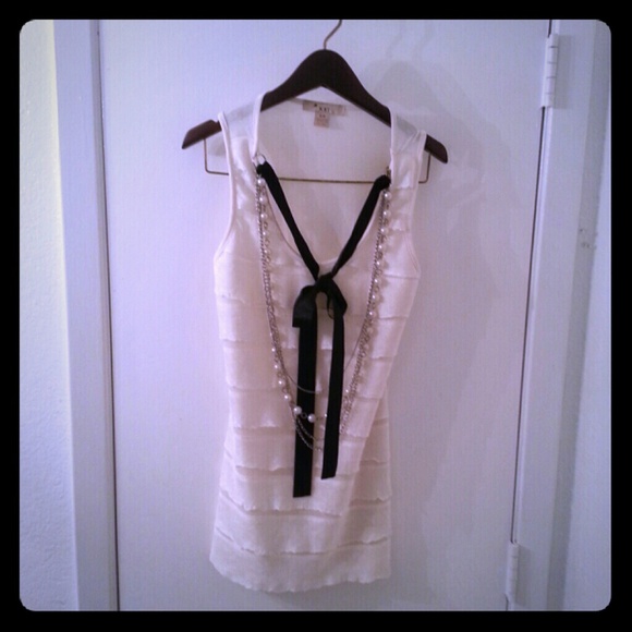 Cream tank with necklaces.