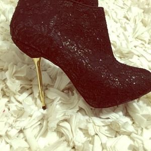 Black booties with gold stiletto heel. Great cond.