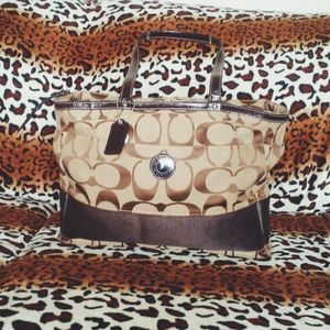 Brown COACH diaper bag or oversized handbag.