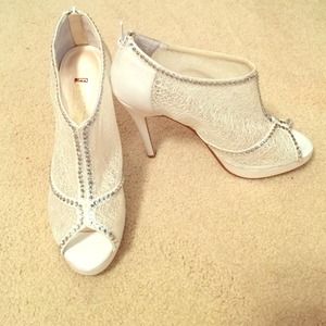 White peep toe pumps with rhinestone detailing