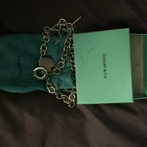 Silver link necklace with heart charm.