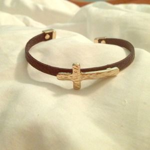 Black leather strap with gold cross bracelet