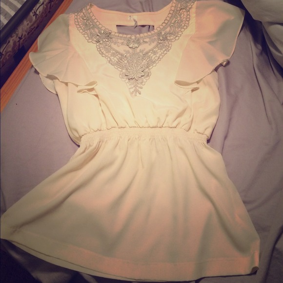 Beautiful creme and silver top.