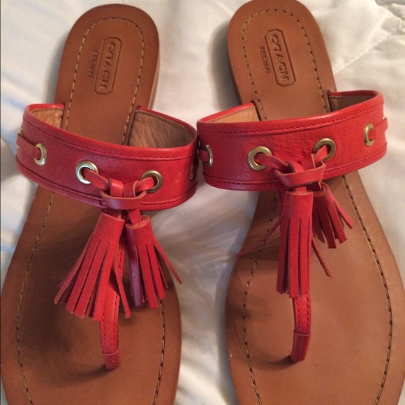 Coral colored Coach sandal.
