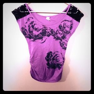 Purple top with black lace sleeves.