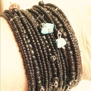 SOLD.   Black cuff bracelet with beads and stones