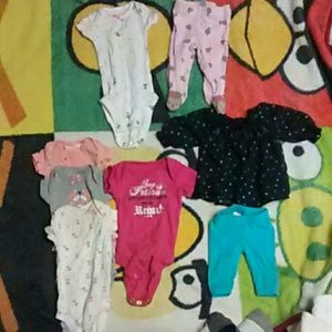3 new born onesies and two new born outfits