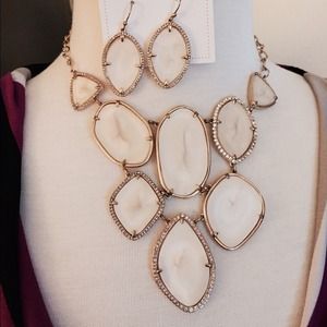 Cream and gold colored necklace and earrings