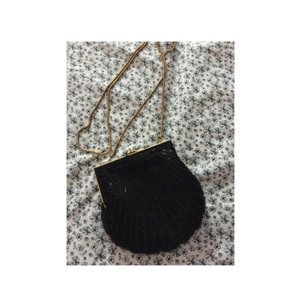 Carla marchi black purse with golden strap.
