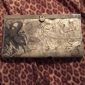 Gray wallet with butterflies on it.
