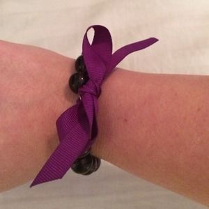 Purple bow bracelet.