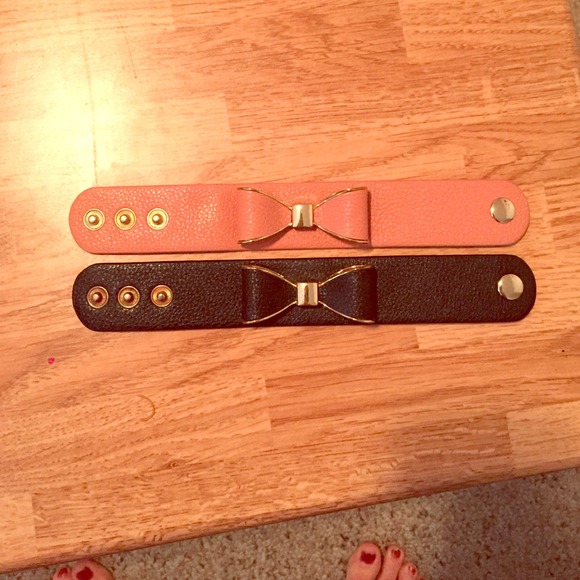 Two adjustable leather bow bracelets.