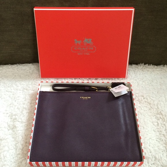 Coach plum leather clutch. Can fit iPad mini