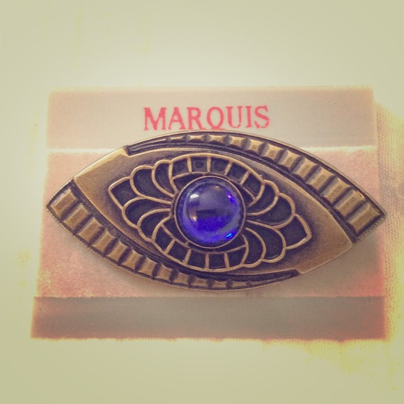 Art Deco style brass brooch with blue center stone