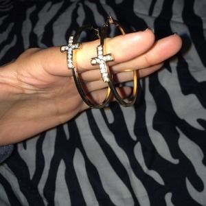 Gold cross earrings.