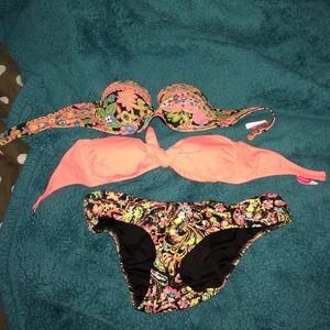Two bathing suit tops and one bottom