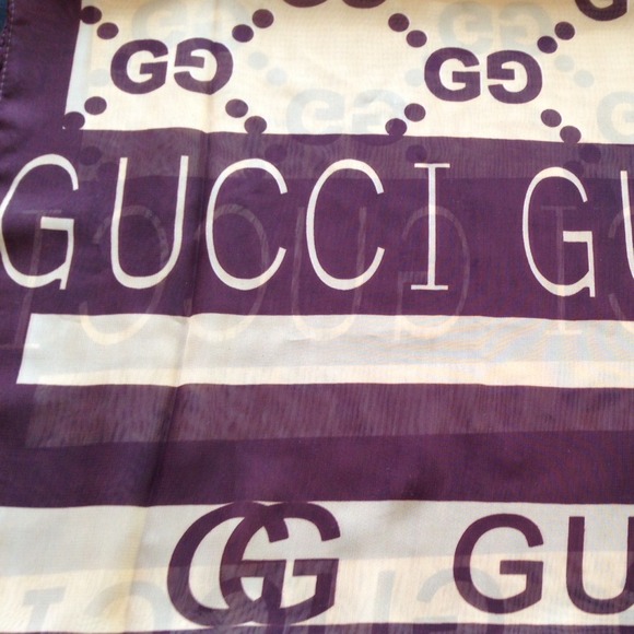 Two tone brown sheer scarf with the Gucci name.