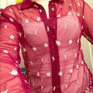 Sheer, button up shirt with little white designs.