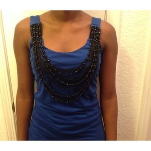 Blue top with beaded necklace attached.