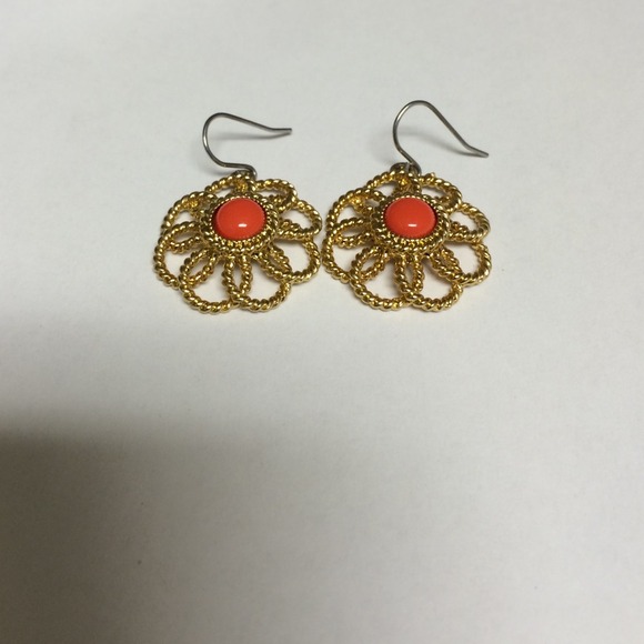 Gold look earrings with coral colored stone