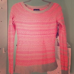 A coral and tan sweater.