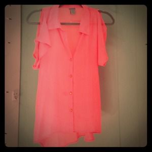 A bright neon blouse with gold buttons