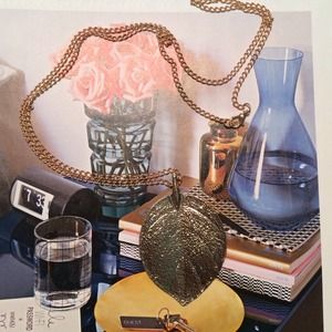 Long gold chain with leaf pendant necklace