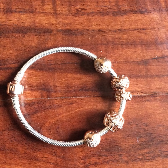 Sterling silver PANDORA bracelet. Rose gold charms