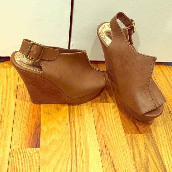 Pair of never worn, peep toe faux leather wedges.