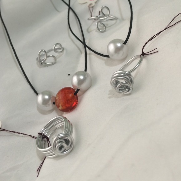 Two pearled necklaces w/ four silver wired rings