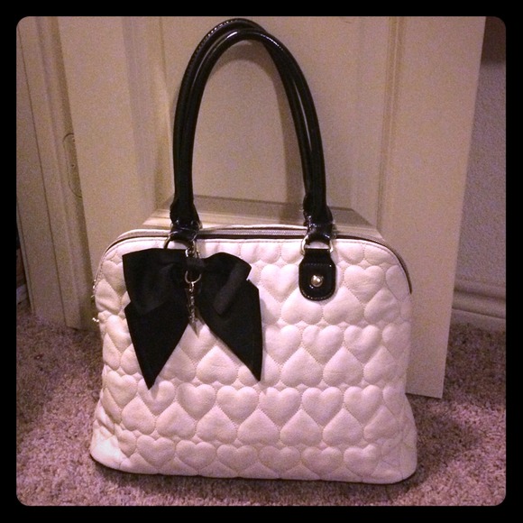Cream Betsey Johnson handbag.