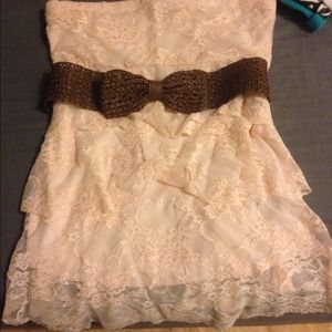 Cute strapless top with bow/belt around waist.