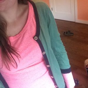 Green cardigan with blue piping and gold buttons