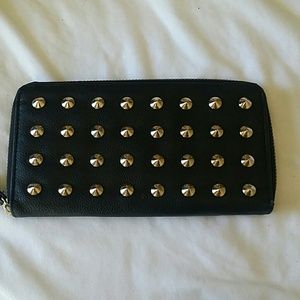 Faux leather black studded wallet .