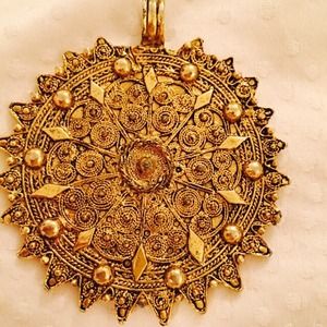 Vintage gold pendant carved details