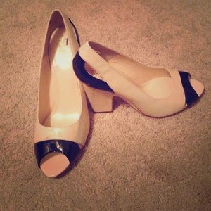 Isola cream and black peep toe pumps