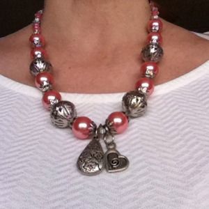 Necklace.  faux pink/copper pearls and charms.