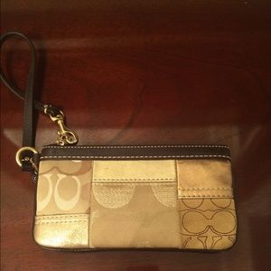 A gold coach wristlet