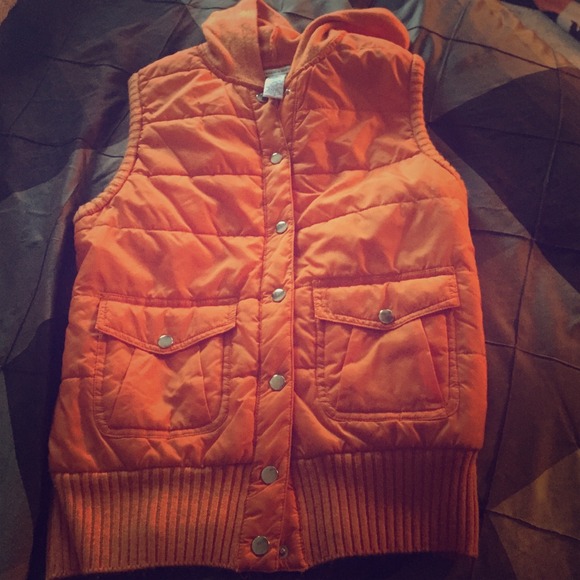 Orange puffy button up hooded vest.