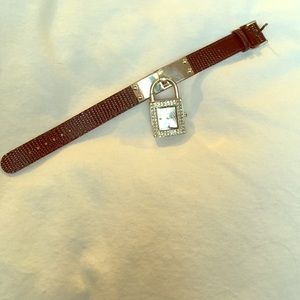 Watch with dangling lock face and snake skin band.