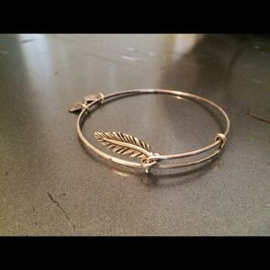 Silver bracelet with feather charm.