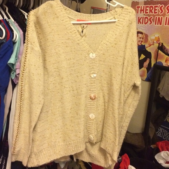 Beige sweater, gold accents & a tie up the back!