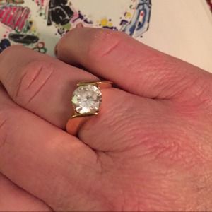 Gold tone solitaire ring.