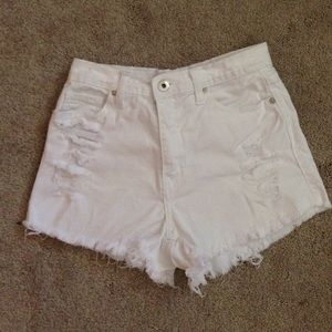 White high waisted distressed shorts.
