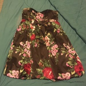 A brown base color dress with colorful flowers.