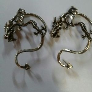 Dragon earrings around the ear.