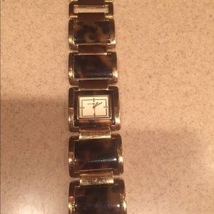 Michael Kors gold and tortoise watch.
