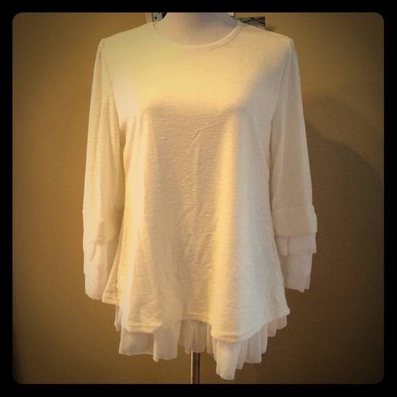 A very soft ruffled  blouse in cream color. NWOT.
