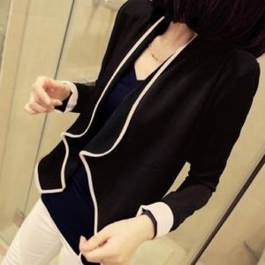 Short Black cardigan w/apricot/nude piping.